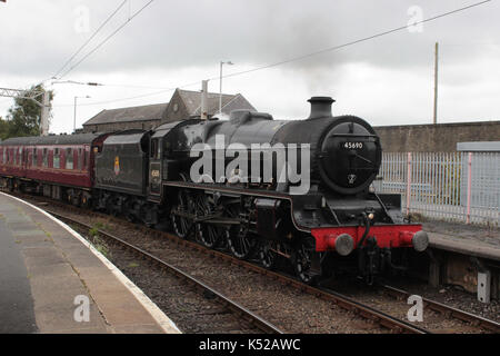 Jubilee class steam locomotive number 45690 named Leander arriving at Carnforth railway station seen entering Platform 1. Stock Photo
