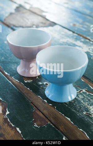 Close-up of two ceramic bowls on wooden table Stock Photo