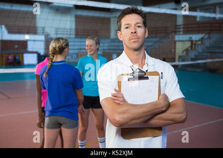 Portrait of confidence male coach standing in the court Stock Photo