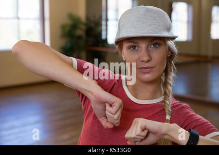 Portrait of young woman practicing dance on floor in studio Stock Photo
