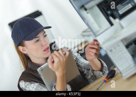 technician using tablet pc while analysing server Stock Photo