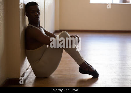 Depressed ballerino sitting in the studio Stock Photo