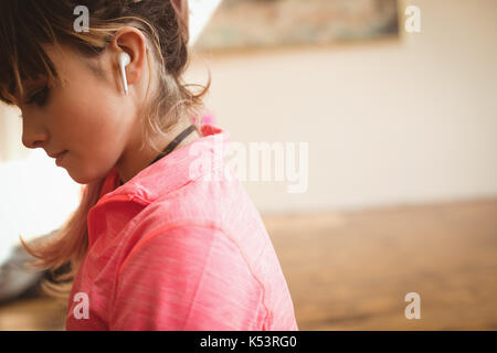 Side view of thoughtful young woman at yoga studio Stock Photo
