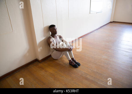 Depressed ballerino sitting in the studio Stock Photo