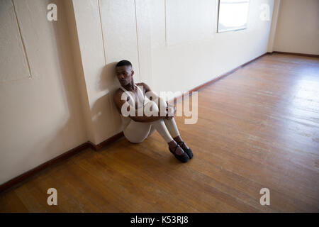 Depressed ballerino sitting in the studio Stock Photo