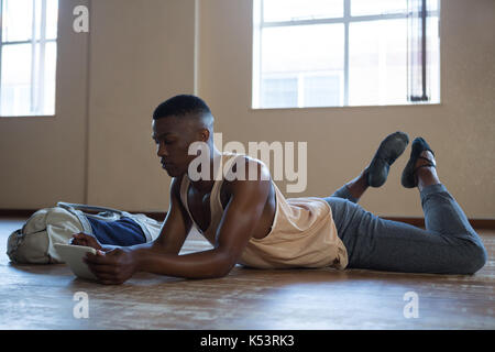 Ballerino using digital tablet in the studio Stock Photo