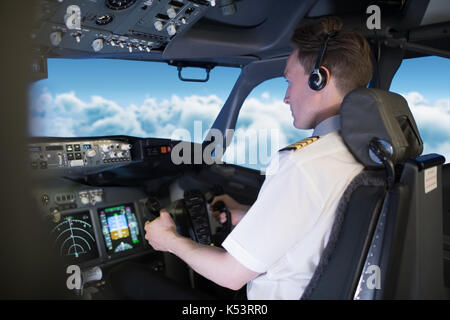 Side view of young male pilot flying air vehicle Stock Photo