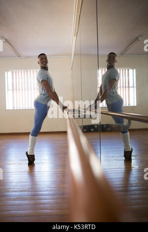 Ballerino practicing ballet dance at barre in ballet studio Stock Photo