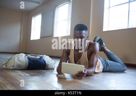 Ballerino using digital tablet in the studio Stock Photo