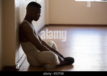 Depressed ballerino sitting in the studio Stock Photo