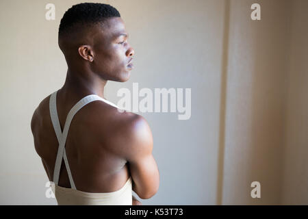 Thoughtful ballerino standing in the ballet studio Stock Photo