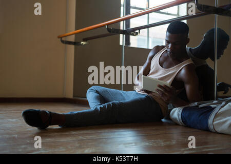 Ballerino using digital tablet in the studio Stock Photo