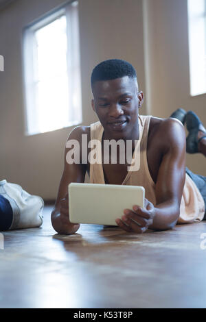 Ballerino using digital tablet in the studio Stock Photo