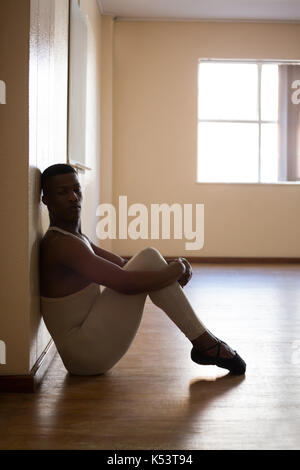 Depressed ballerino sitting in the studio Stock Photo