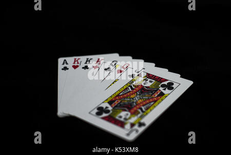 Splattered Playing Cards on a table Stock Photo