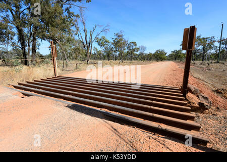 Cattle grid on a remote unsealed Outback road near Undara, Queensland, QLD, Australia Stock Photo