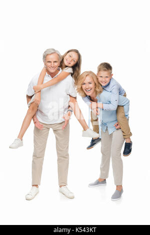 kids piggybacking on grandparents Stock Photo