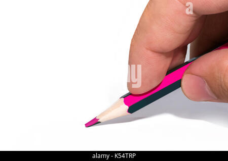 man's hand holds a two-tone color pencil on white isolated background. Pencils with double colo Stock Photo