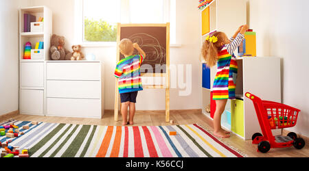 little child drawing on the blackboard Stock Photo