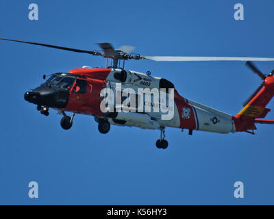 U.S. coast guard helicopter flying near Ocean Shores city in Washington state Stock Photo