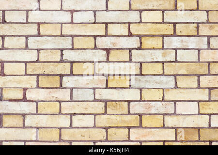 Wall of beige and yellow bricks Stock Photo