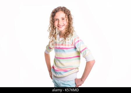 Portrait of happy, smiling, confident 9 years old girl with curly hair, isolated on white Stock Photo