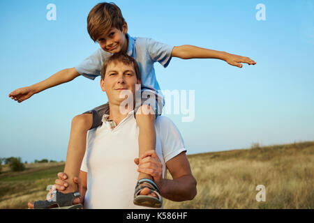 Son with father in the open air in the field. Stock Photo