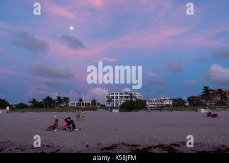 Delray Beach, Florida, USA. 8th Sep, 2017. People sit and enjoy the beach at sunrise and the moon in Delray Beach, Fla., Septembert. 08, 2017. Irma's tracking has shown her to make landfall on southern Florida coast by this weekend. Credit: Ken Cedeno/ZUMA Wire/ZUMAPRESS.com/Alamy Live News Stock Photo