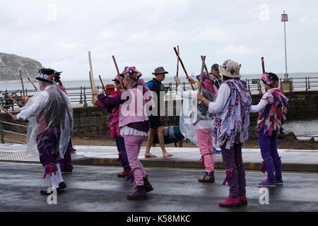 Swanage, Dorset, UK. 9th Sep, 2017. 25th anniversary of the Swanage Folk Festival takes place with a day of mixed weather of sunshine and rain, but the rain doesn't deter spirits. Morris dancers members of Guith Morris side dance along the promenade. Credit: Carolyn Jenkins/Alamy Live News Stock Photo