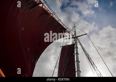 Traditional Gaff Rigged Sailing Boat Close up of Sails and Main Mast against the sky. Stock Photo