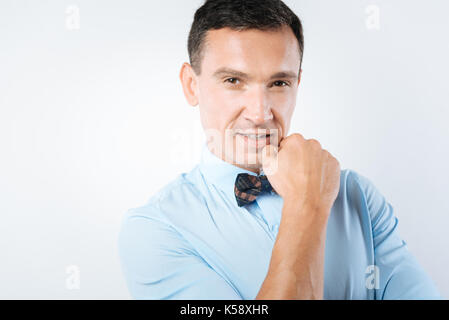 Thoughtful nice man holding his chin Stock Photo