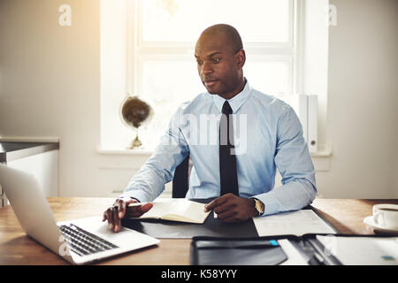 Focused African American Businessman In A Protective Mask Works At A 