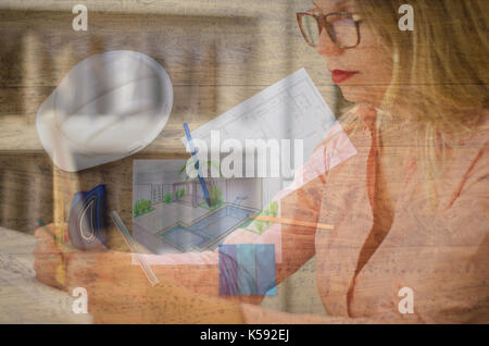 Double exposure of woman working on architectural projects Stock Photo