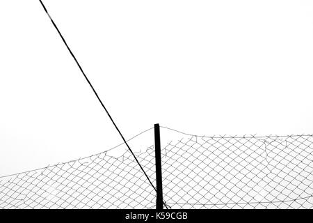Rusty chain link fence silhouette and cable abstract background. Black and white. Stock Photo