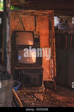 Vintage old television TV sets broken and ruined inside abandoned house Stock Photo