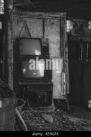 Vintage old television TV sets broken and ruined inside abandoned house Stock Photo