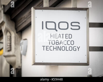 IQOS Technology sign outside a shop in Soho London - IQOS is marketed by Philip Morris International and is a heat-not-burn product Stock Photo