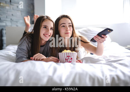 friendship, people, pajama party, entertainment and junk food concept Stock Photo