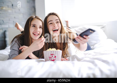friendship, people, pajama party, entertainment and junk food concept Stock Photo