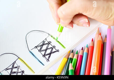 Person coloring art for class homework.  Education art supplies including colored pencils. Stock Photo