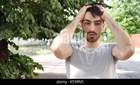Surprised, shocked young man looking at camera Stock Photo