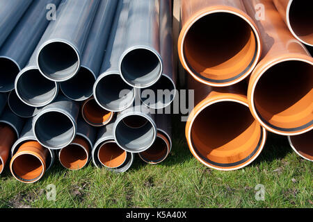 Drain pipes lying on a construction site Stock Photo