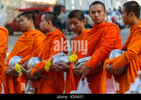 CHIANG MAI, THAILAND - 1/8/2016: Young monks collect donations in Chiang Mai, Thailand. Stock Photo