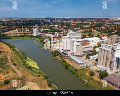 Aerial drone pov view of industrial cityscape with factory buildings and warehouses Stock Photo