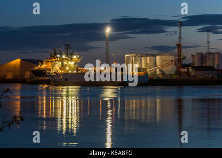 Aberdeen, Scotland, UK, August 30th 2017. Aberdeen harbour pier and oil transportation ship at night.