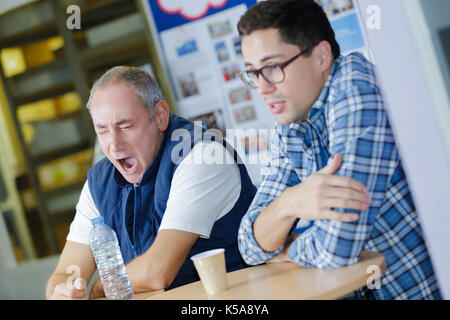 two attractive construction workers having a coffee break Stock Photo