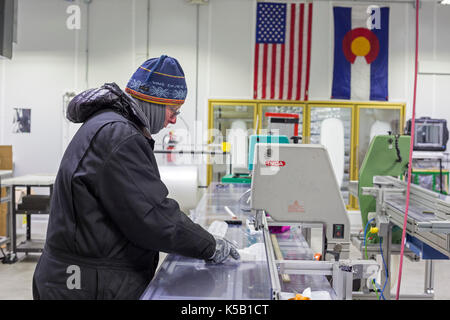 Denver, Colorado - Geoff Hargreaves, curator at the National Ice Core Laboratory, cuts an ice core from Greenland. The lab stores 19,000 meters of ice Stock Photo