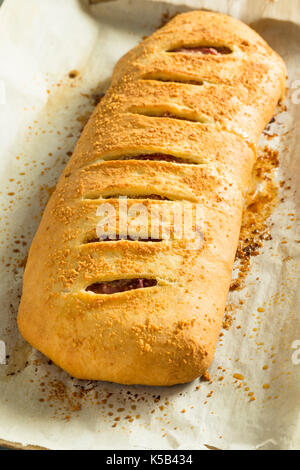 Homemade Cheesy and Meaty Italian Stromboli with Marinara Sauce Stock Photo