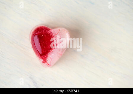 Ice heart on a vintage table Stock Photo