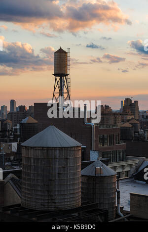 Summer sunset with Chelsea rooftops, and water towers. Manhattan, New York City Stock Photo